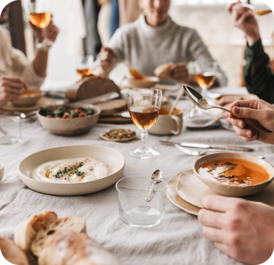 Guests seated at a dining table enjoying meals in a full-service restaurant setting.